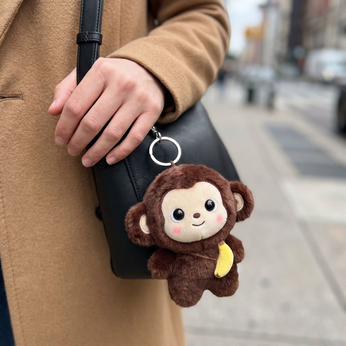 Cocoa Monkey Bag Charm on a shoulder bag
